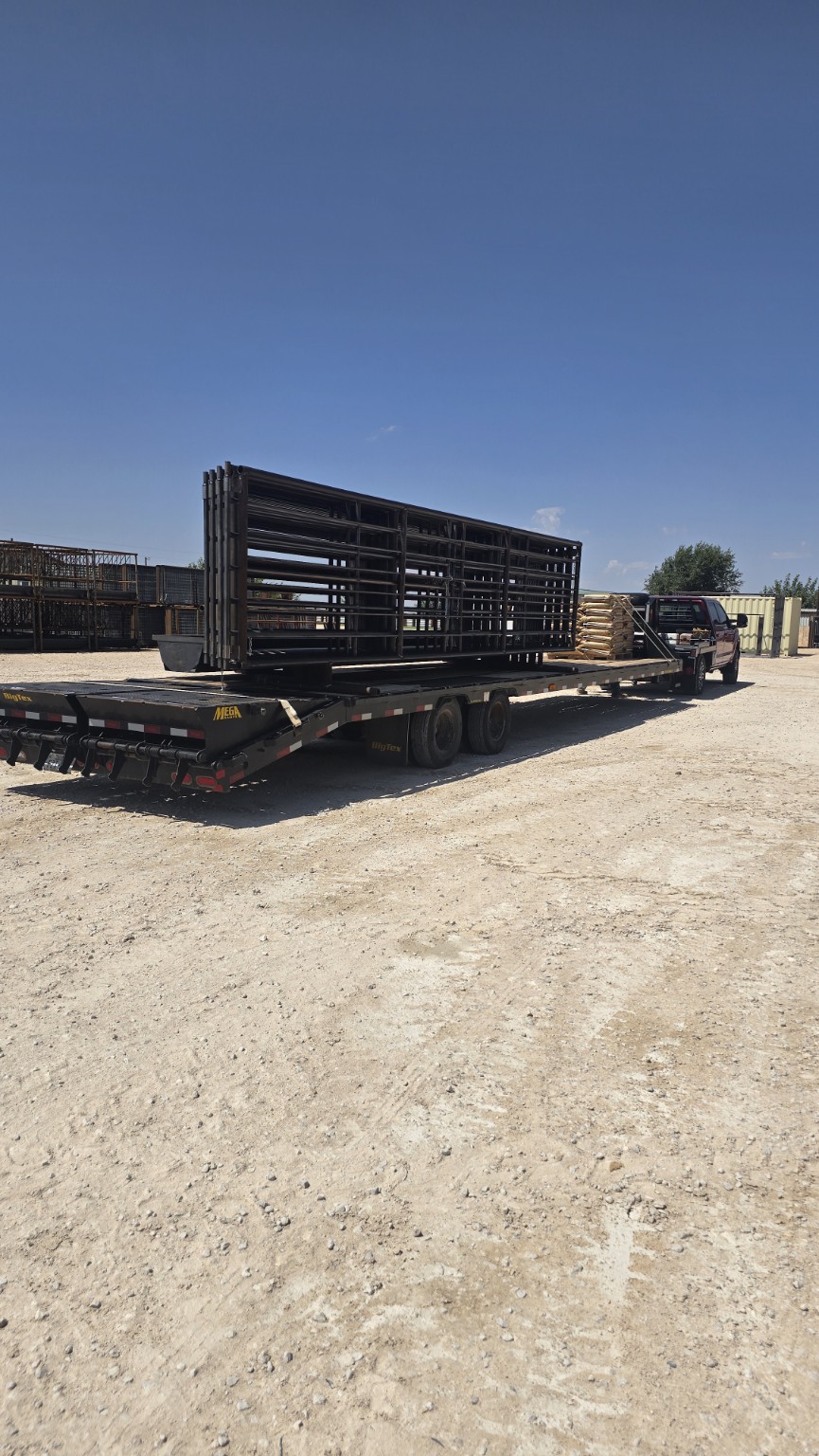 Freestanding livestock panels secured on a flatbed trailer