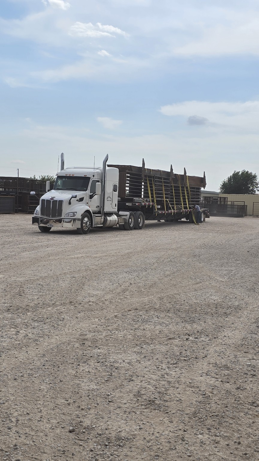 White semi hauling a full load of TX Panels equipment