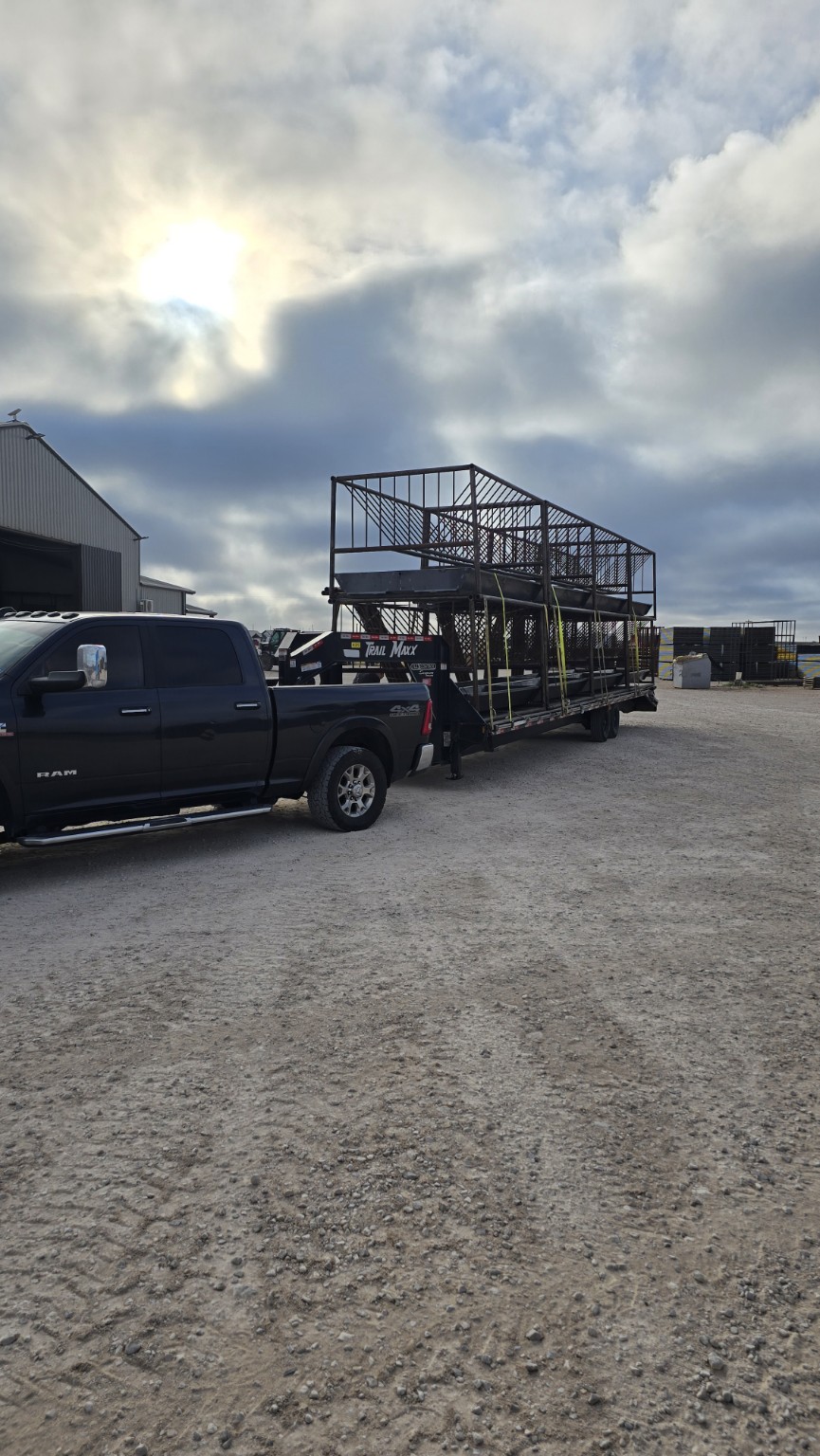 Pickup and trailer hauling livestock equipment from TX Panels
